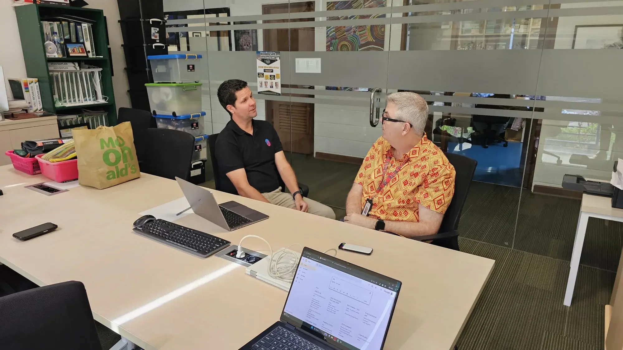 Craig talking with a school educator during a working visit